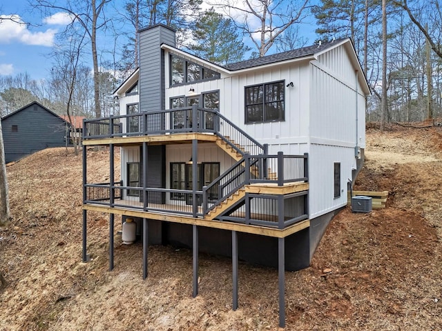 rear view of property with a deck and central air condition unit