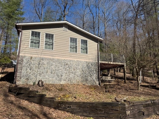 view of side of home featuring a deck