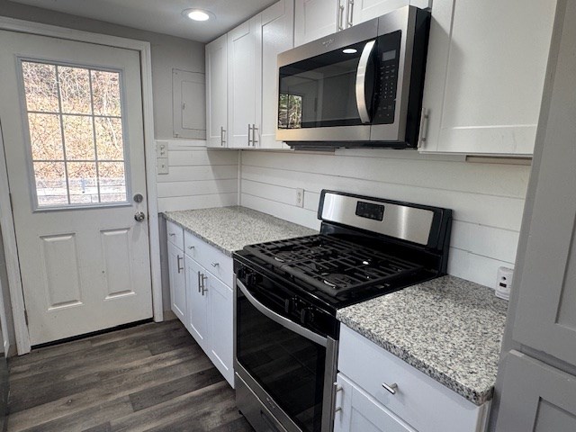 kitchen featuring dark wood finished floors, white cabinets, and appliances with stainless steel finishes