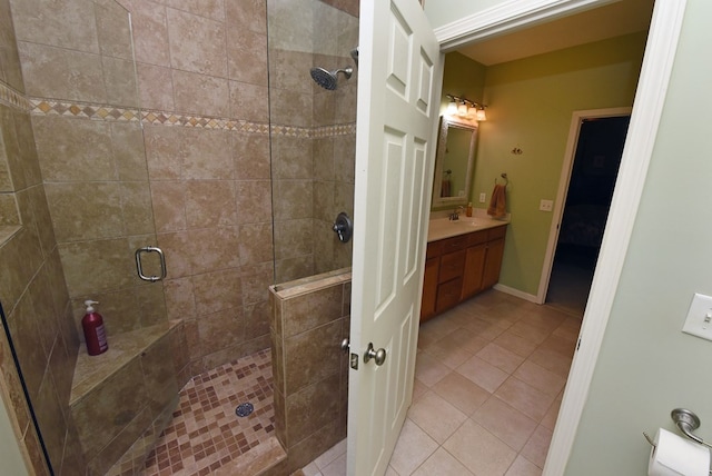 bathroom featuring tile patterned flooring, vanity, and a shower with shower door