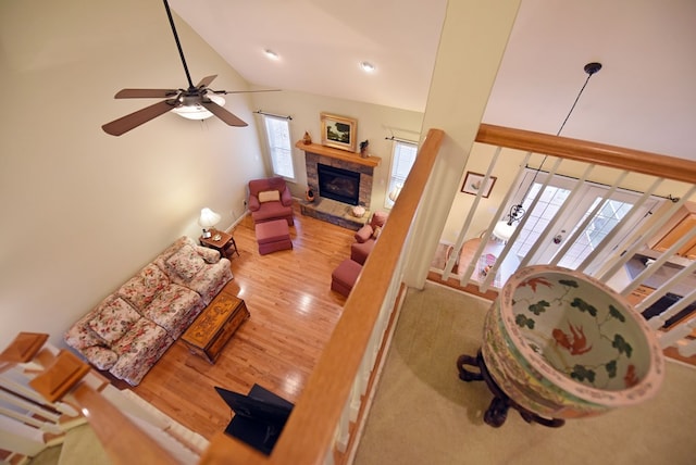 living room featuring ceiling fan, french doors, wood-type flooring, and vaulted ceiling