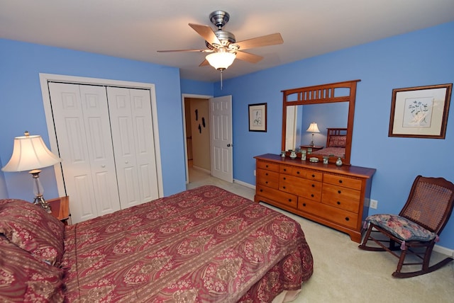 carpeted bedroom featuring ceiling fan and a closet