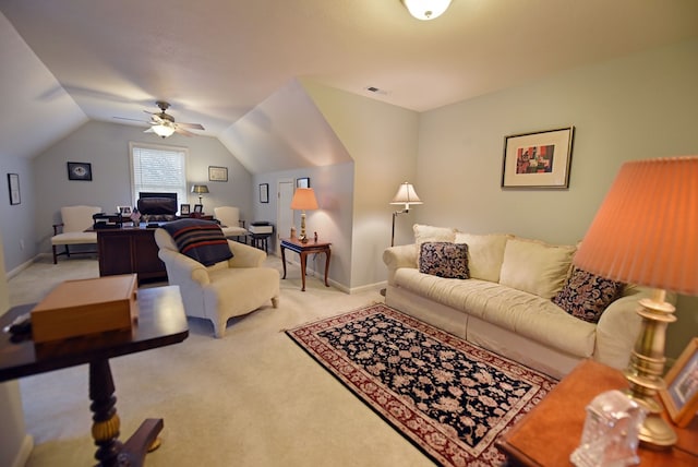 carpeted living room featuring ceiling fan and lofted ceiling