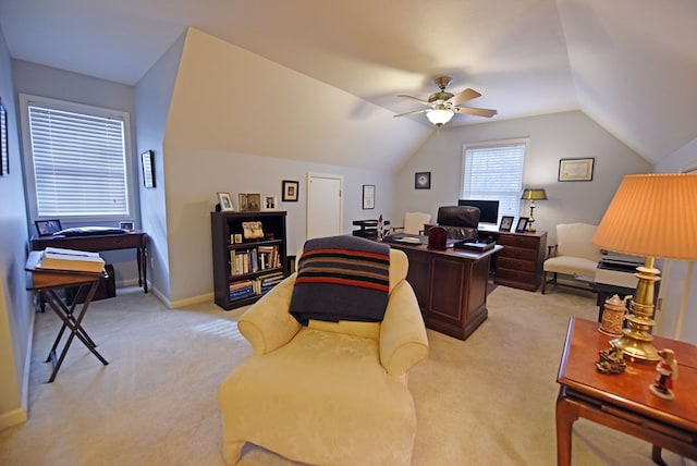 home office featuring ceiling fan, light carpet, and vaulted ceiling