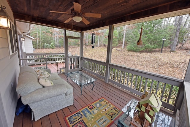 sunroom with ceiling fan and wood ceiling