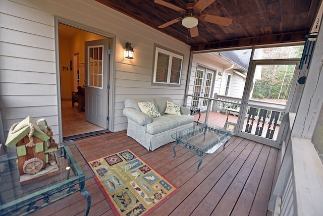 sunroom / solarium featuring ceiling fan and wood ceiling