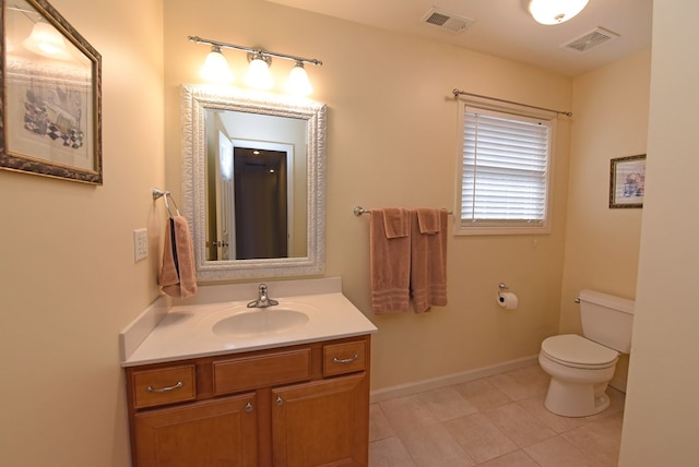 bathroom featuring tile patterned floors, vanity, and toilet