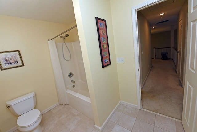 bathroom with tile patterned flooring, shower / bath combination with curtain, and toilet