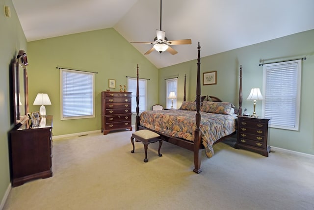 carpeted bedroom with ceiling fan and high vaulted ceiling