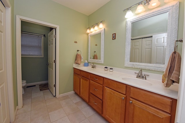 bathroom featuring tile patterned flooring, vanity, and toilet