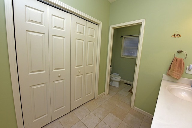 bathroom featuring tile patterned floors, vanity, and toilet