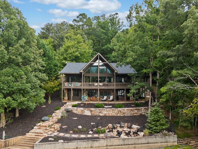 back of house with a patio area, a wooden deck, and stairs