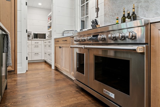 kitchen featuring dark wood finished floors, backsplash, double oven range, and light countertops