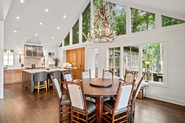 dining space featuring recessed lighting, high vaulted ceiling, and dark wood-style flooring