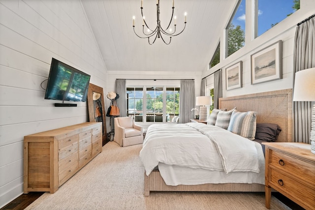 bedroom featuring a notable chandelier and high vaulted ceiling