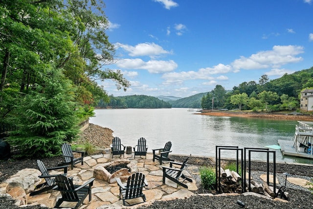 view of patio featuring a water view and a fire pit