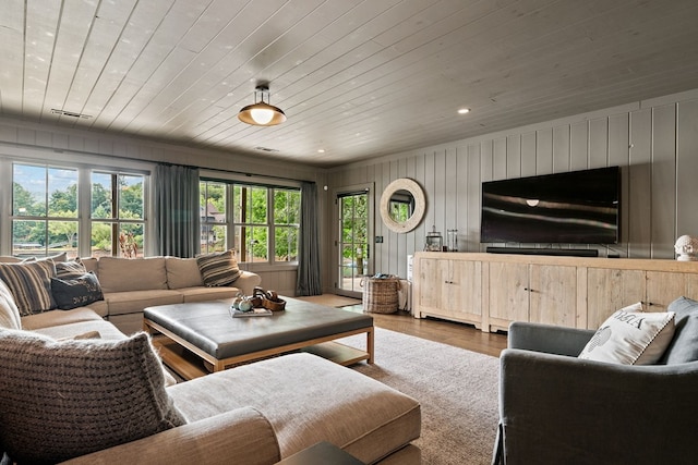 living room featuring recessed lighting, wood finished floors, and wooden ceiling