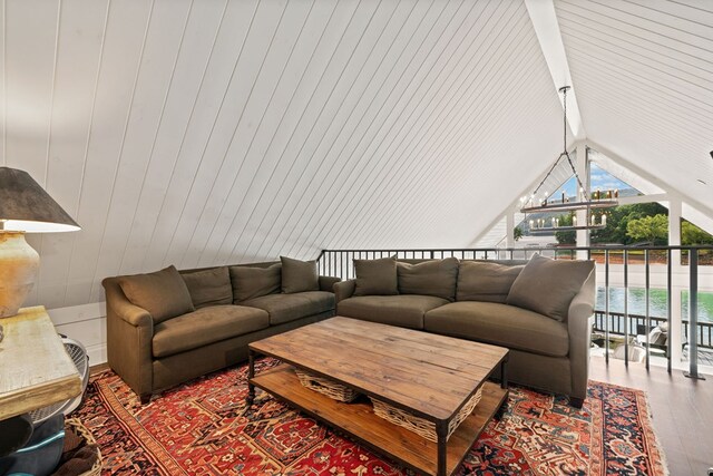 living room featuring lofted ceiling and wood finished floors