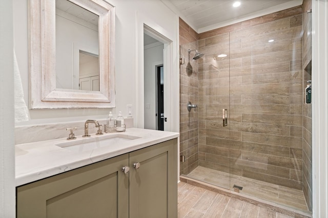 bathroom with a shower stall, vanity, and wood finished floors