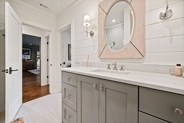 bathroom featuring tile patterned floors, visible vents, vanity, and crown molding