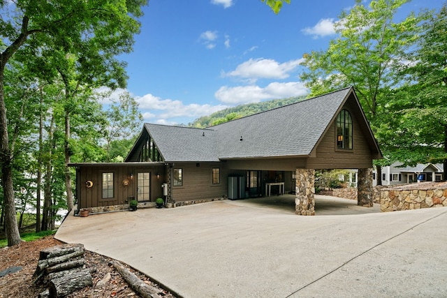 chalet / cabin with board and batten siding and roof with shingles