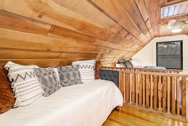 bedroom featuring wood walls, lofted ceiling, hardwood / wood-style floors, and wooden ceiling