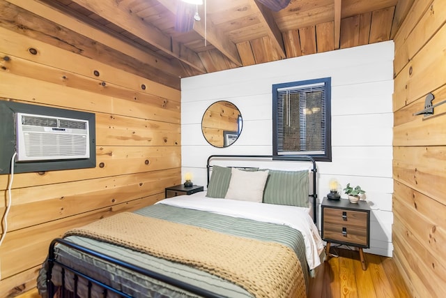 bedroom featuring a wall mounted air conditioner, wood walls, beamed ceiling, wood-type flooring, and wooden ceiling