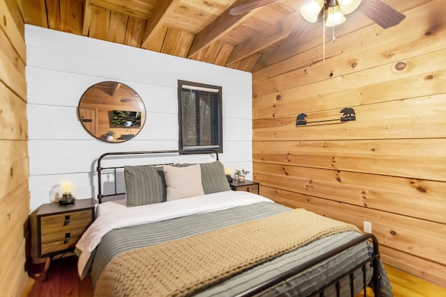 bedroom featuring wood ceiling, wood walls, and beamed ceiling