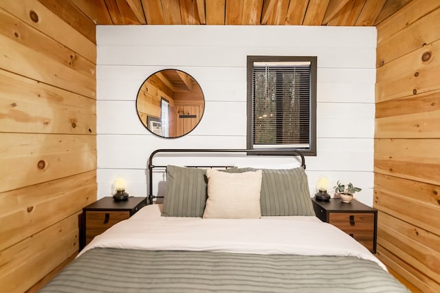 bedroom with wooden ceiling and wood walls