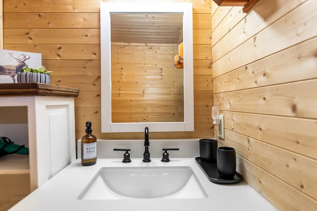 bathroom featuring vanity and wood walls