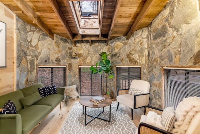 interior space with beamed ceiling, hardwood / wood-style floors, and wooden ceiling