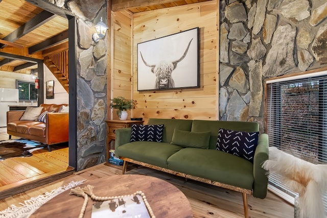 sitting room with beam ceiling, wood ceiling, hardwood / wood-style flooring, and wooden walls