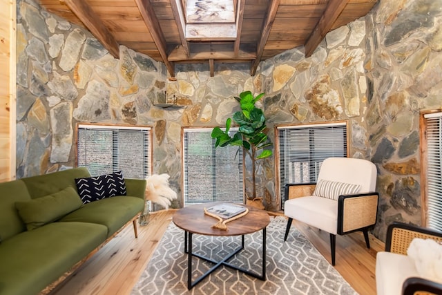 interior space featuring hardwood / wood-style floors, wooden ceiling, and beam ceiling