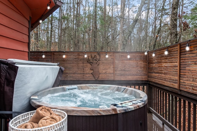 wooden deck featuring a hot tub