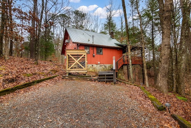 rear view of house featuring a deck