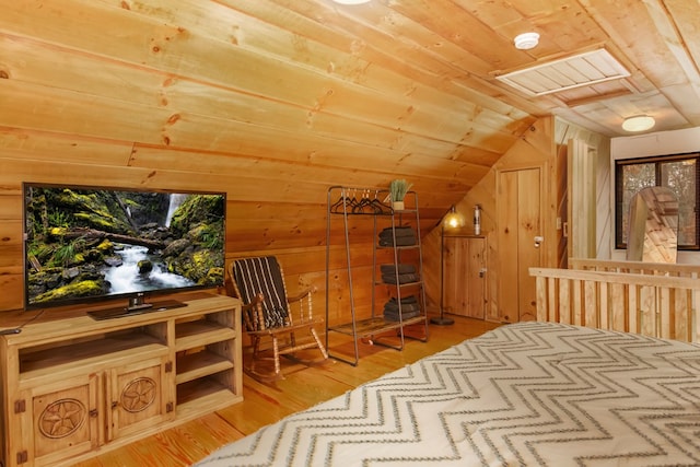 bedroom with hardwood / wood-style flooring, wood ceiling, vaulted ceiling, and wood walls