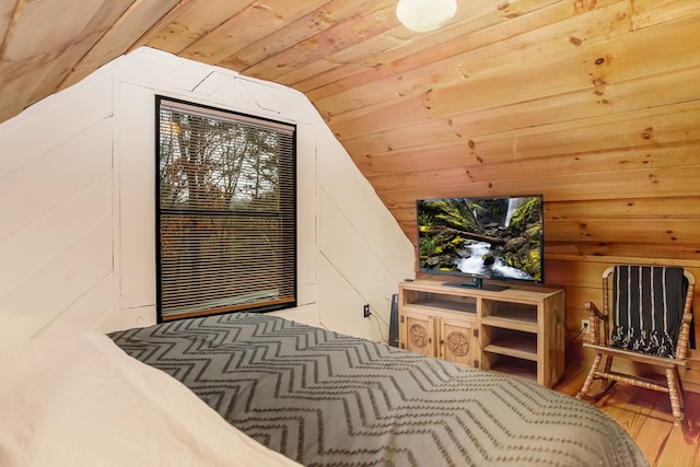 bedroom featuring hardwood / wood-style flooring, wood walls, vaulted ceiling, and wooden ceiling