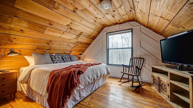 bedroom featuring wood ceiling, lofted ceiling, wooden walls, and light wood-type flooring