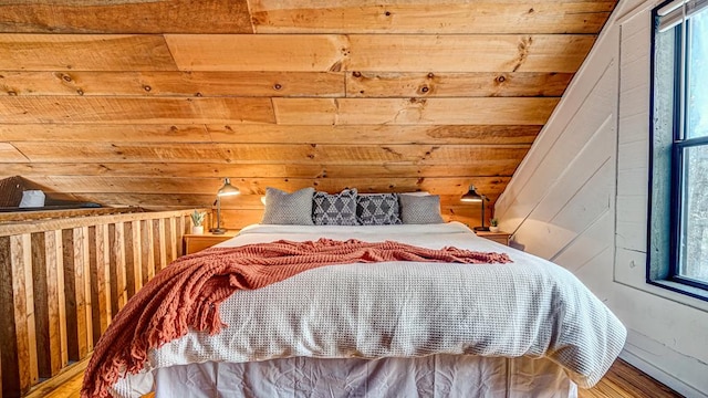 bedroom featuring wooden walls and multiple windows