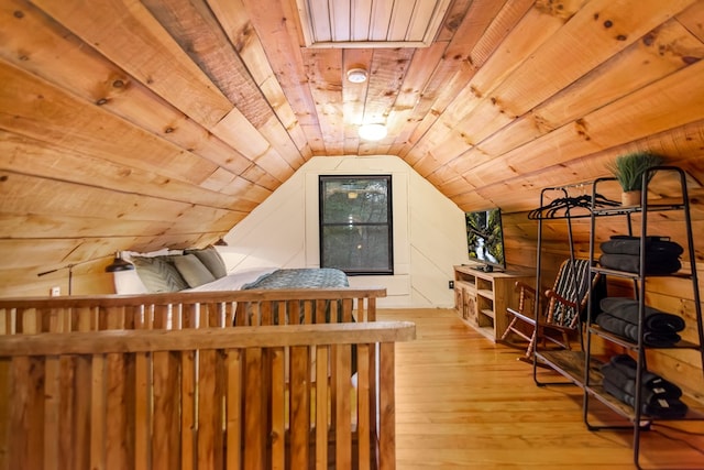 bedroom featuring lofted ceiling, wood ceiling, and light hardwood / wood-style floors