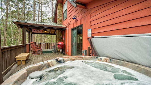 deck featuring area for grilling and a hot tub