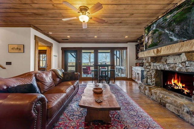 living room featuring a fireplace, hardwood / wood-style floors, ceiling fan, and wood ceiling