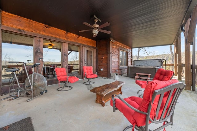 view of patio / terrace with a ceiling fan and a hot tub