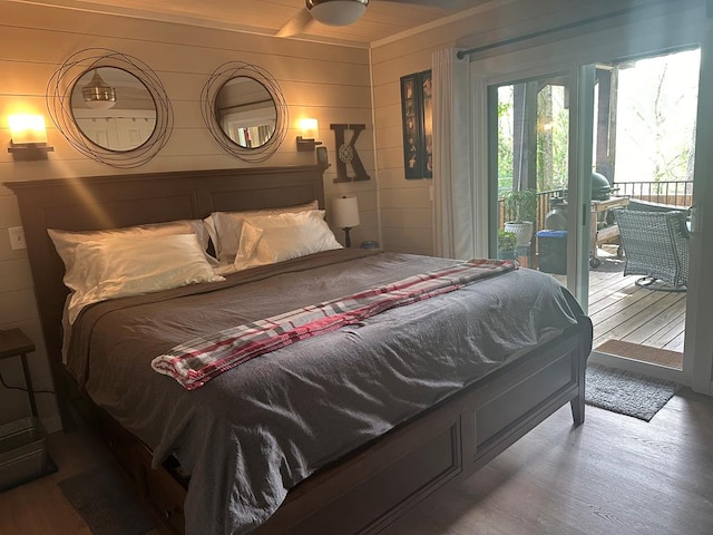 bedroom featuring hardwood / wood-style flooring and access to exterior