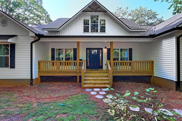 exterior space with covered porch and a shingled roof