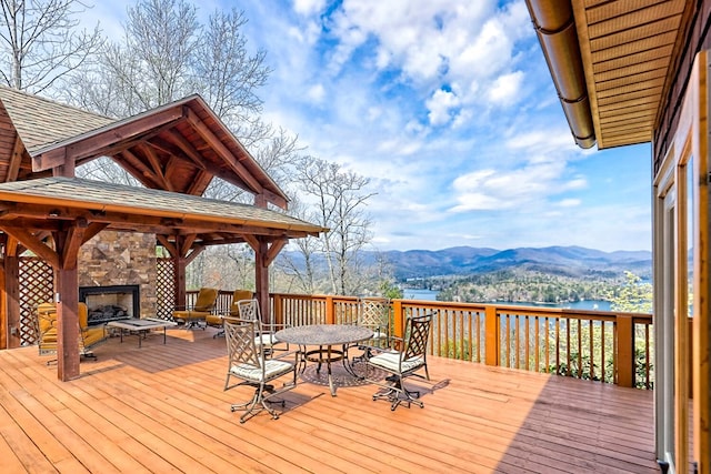 444 Wild Turkey, Tiger, GA 30576 - wooden deck featuring outdoor dining space, a gazebo, a mountain view, and a stone fireplace