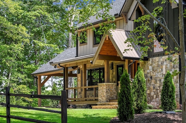 exterior space with a porch and a lawn