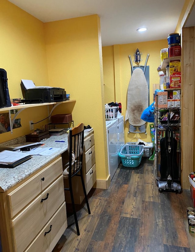 home office featuring dark wood-type flooring, washer and clothes dryer, and built in desk