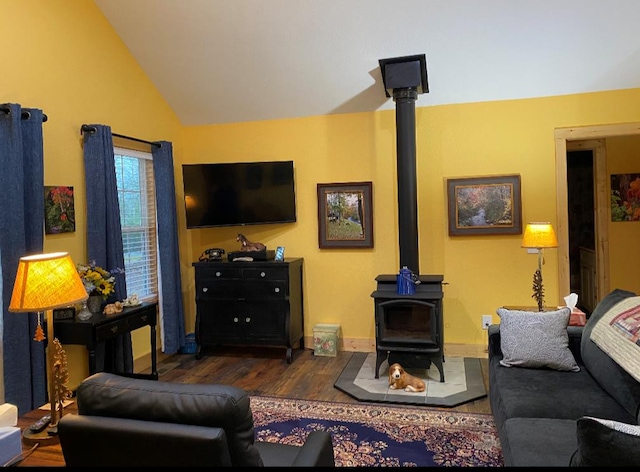 living room featuring lofted ceiling, dark hardwood / wood-style floors, and a wood stove