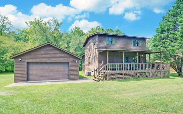 view of front of property with an outbuilding, a front lawn, a porch, and a garage